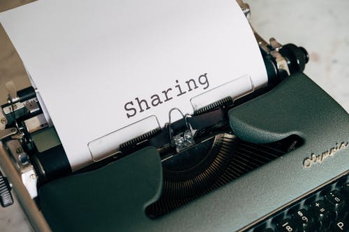 typewriter with a page that says sharing